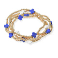 Gold beaded bracelet with blue star-shaped beads on a white background
