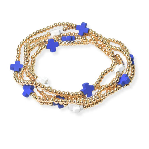 Gold beaded bracelet with blue star-shaped beads on a white background